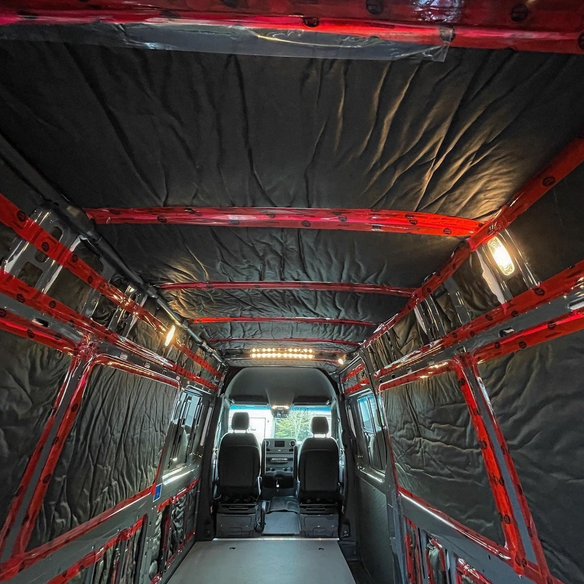 Thinsulate installed across the walls and ceiling of a real camper van before interior panels