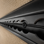 Black L-track mounting screw installed through L-track into van back framing